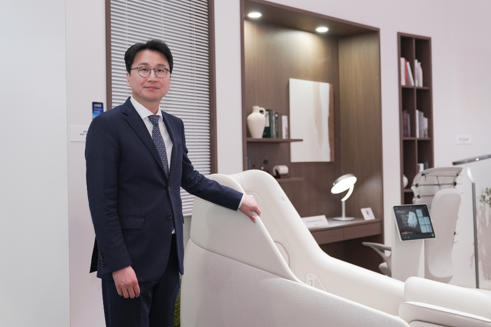 CERAGEM CEO Lee Kyung-soo standing beside a white wellness chair at CES 2026.